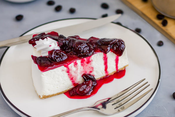 Cheesecake with blueberry & blackberry drizzle